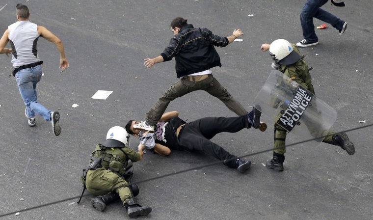 Riot police fight with demonstrators during clashes in front of the parliament in Athens on Tuesday Oct. 9, 2012.