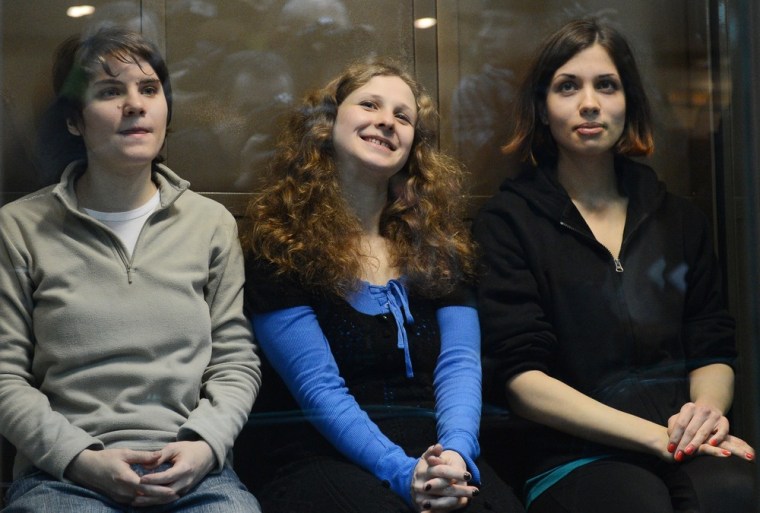 Yekaterina Samutsevich, center, was freed by an appeal court after her sentence was suspended; but the court upheld two-year prison terms for Maria Alyokhina, left and Nadezhda Tolokonnikova, right, seen in court Wednesday.
