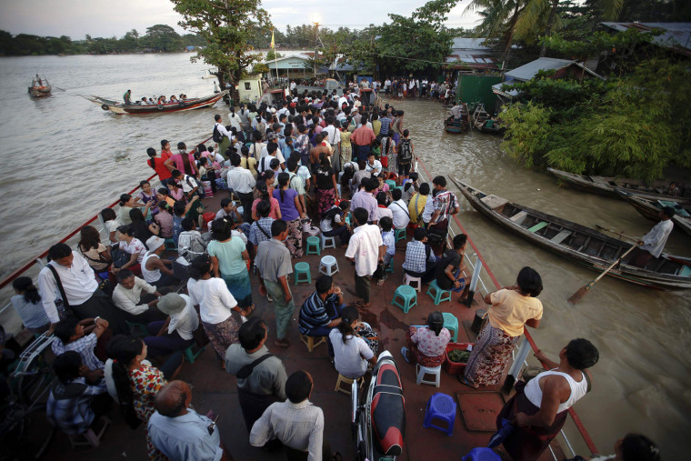 Passengers traveling on a government-owned ferry get ready to disembark at the Dallah township of Yangon, Sept. 18. Dallah Township, a short ferry ride cross the river, is the place where the big city touches the province. Thousands of daily migrants cross the river to Dallah using dangerous long tail boats and cheap government operated ferries.