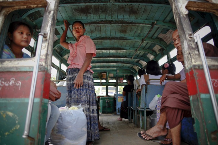 Passengers wait for a Bayboo bus to leave the station in North Dagon Township, Sept. 18. On line 61, several Bayboo, meaning 'big belly' in Burmese, buses take passengers from North Dagon Township to the city. Possibly the oldest operating bus in the world,