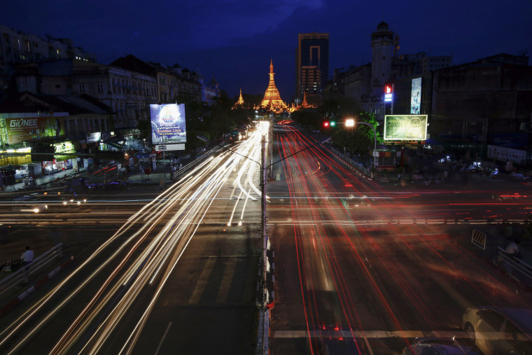 Vehicles pass the intersection in front of the Sule Pagoda in central Yangon, Myanmar, Sept. 24, 2012. Yangon is a town of taxis, small privately owned buses and other improvised vehicles providing alternative to the choking public transport.