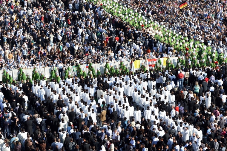 Bishops walk in a solemn procession through St Peter's Square as they arrive for a mass led by the pontiff.