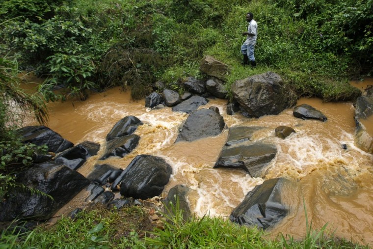 Anastase Tabaro, a self-taught engineer, walks by a stream near his hydroelectricity generating station in Rutare, Rwanda.
