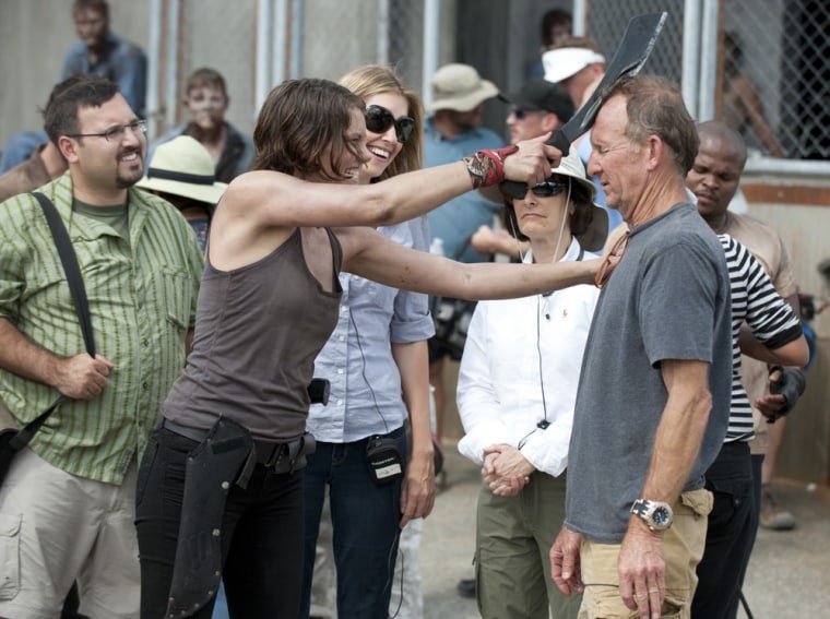 Star Lauren Cohan tests out a rubbery blade for a scene from the season three premiere of \"Walking Dead.\"
