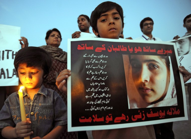 A child holds a portrait of Malala Yousafzai during a vigil to pray for her recovery in Islamabad, Pakistan, on Oct. 11.
