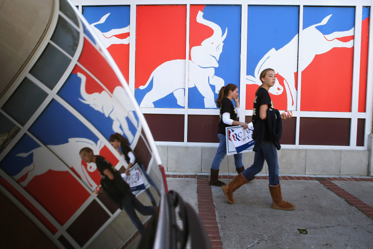 Students walk past a political mural near Centre College in downtown Danville, Ky., Oct. 11.
