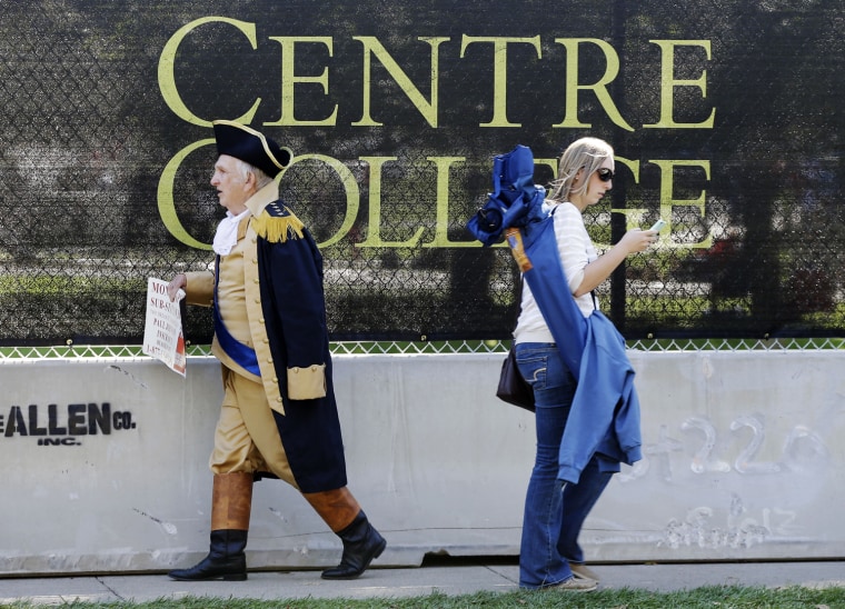 Paul Johnson, dressed as George Washington, walks past a barricade at Centre College, site of the vice presidential debate in Danville, Ky., Oct. 11, 2012. Vice President Joe Biden will face Republican vice presidential candidate Paul Ryan on Thursday night.