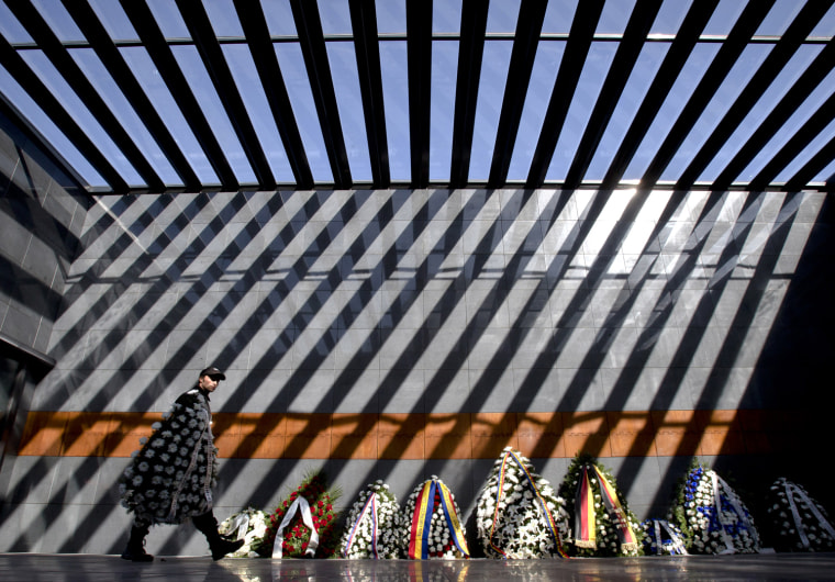 A man carries a wreath inside the Holocaust memorial following National Holocaust Remembrance Day commemorations in Bucharest, Romania, Oct. 10.