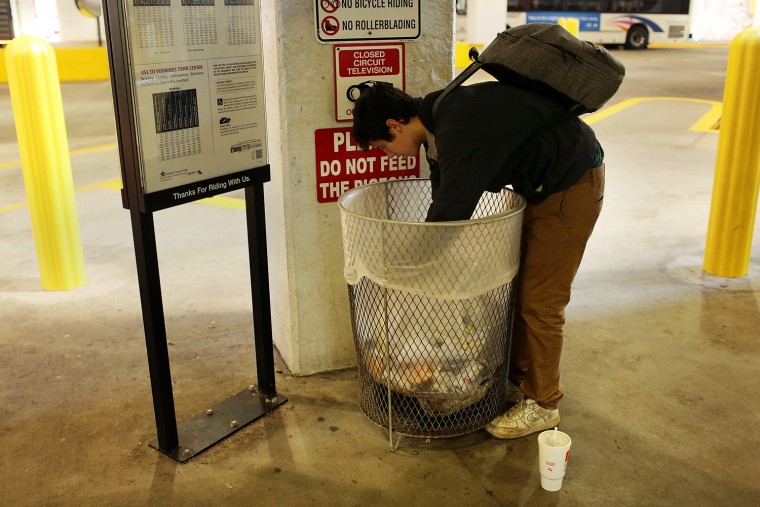 A 21-year-old heroin addict looks for food among garbage in Camden, N.J., Oct. 11, 2012.