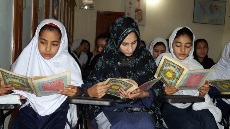 Students recite verses from the Quran as they pray for Malala Yousafzai, who was shot in the head in a Taliban assassination attempt, at her school in Mingora, the main town of Swat Valley on Friday
