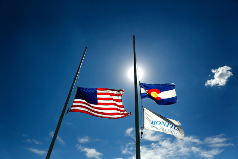 The American and Colorado state flag fly at half mast in honor of the victims of the Aurora theater shootings outside the Bonfils Blood Center.