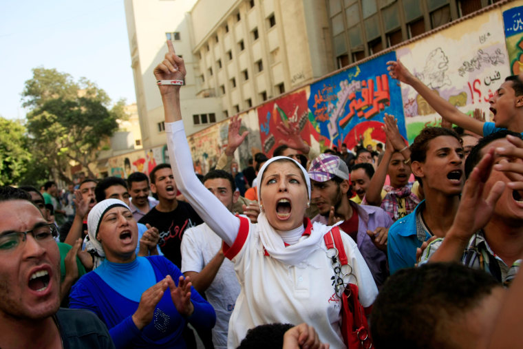 Protesters chant slogans in Tahrir Square in Cairo, Egypt, on Oct. 12. Supporters of Egypt's new Islamist president stormed a stage erected by opposition activists, smashed loudspeakers and tore the structure down during competing protests Friday in Cairo. The scuffles between supporters and opponents of President Mohammed Morsi reflect deep political divisions among the country's 82 million people, more than a year after the popular uprising that toppled Hosni Mubarak.