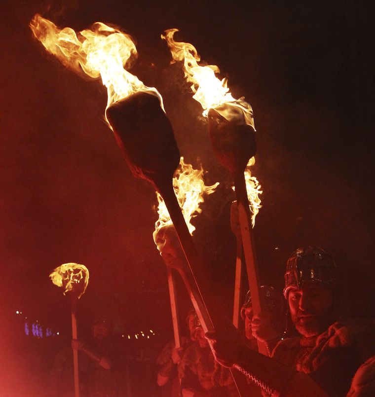Up Helly Aa vikings from Lerwick in the Shetland Islands stand with flaming torches during the annual torchlight procession to mark the start of Hogmanay (New Year) celebrations in Edinburgh Dec. 30, 2011. The annual torchlight procession starts at the Parliament Square and finishes with a fireworks display at Calton Hill in Edinburgh.