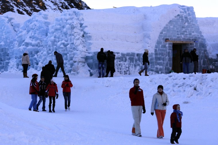 Tourists walk in the snow outside the Balea Lac Hotel of Ice in the Fagaras Mountains, 184 miles northwest of Bucharest on Dec. 28, 2011. Entirely made of ice, the hotel offers accommodation in 10 double rooms with king size beds, where the temperature hovers around freezing.