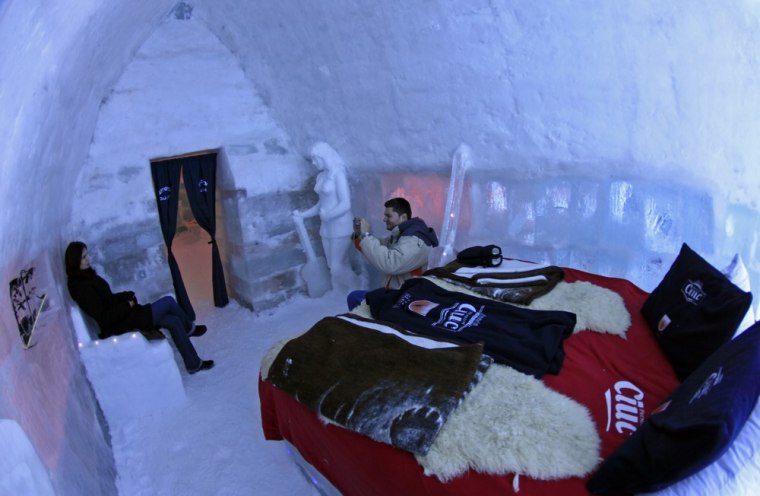 Tourists visit a room inside the Balea Lac Hotel of Ice. Rooms go for $45.73 per person.