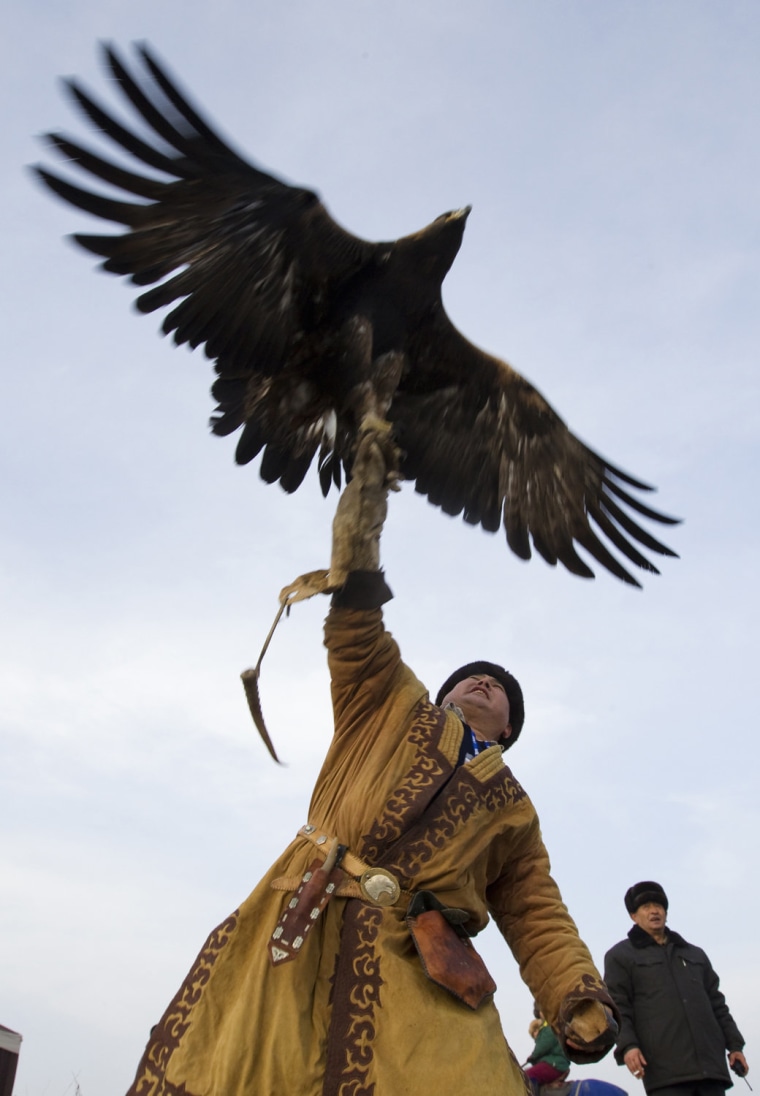 A hunter releases his tame golden eagle during an annual hunting competition outside Almaty, Kazakhstan Dec. 9.
