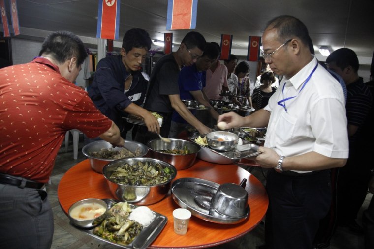 North Koreans and Chinese travel agents eat at a buffet during the trial cruise of the North Korean leisure boat the