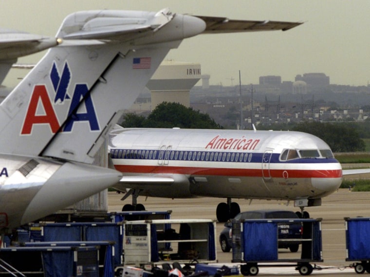 An American Airlines jet pulls into the gate area at Dallas/Fort Worth International Airport in this file photo. AMR Corp, the parent company of American Airlines, filed for voluntary Chapter 11 bankruptcy protection to restructure debt.