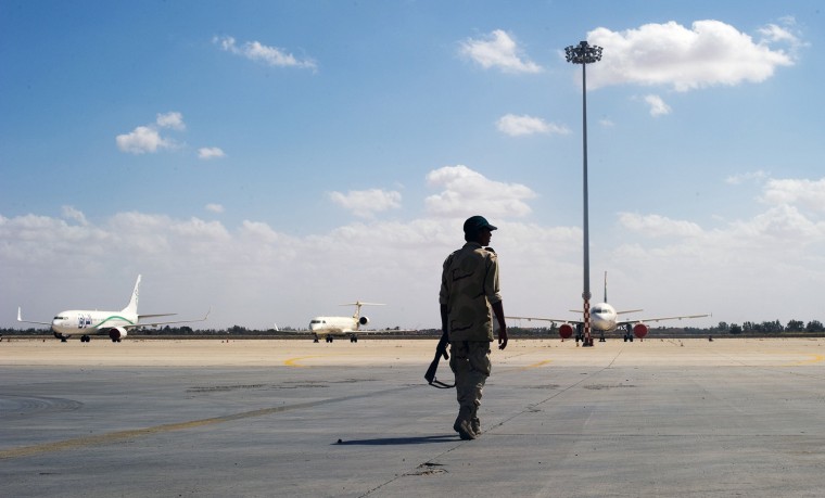 An armed soldier loyal to Libya's new rulers walks on the runway of Tripoli International Airport on September 21 as Turkish Airlines agreed to begin international flights to and from Libya with the capital looking to regain stability.