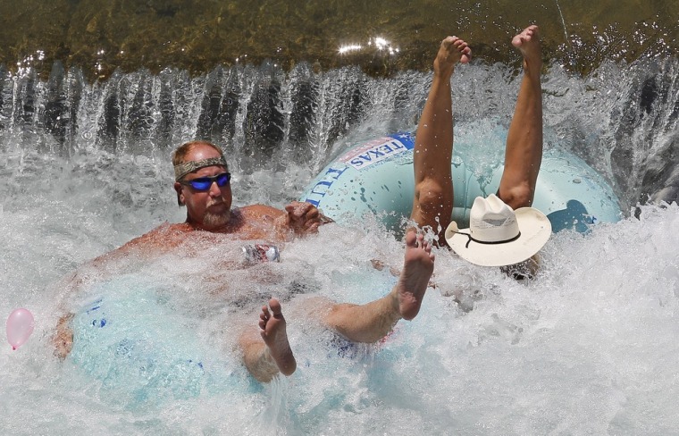Tubers are flipped around as they float the Comal River as Memorial Day Weekend marks the beginning of summer on Friday in New Braunfels, Texas.