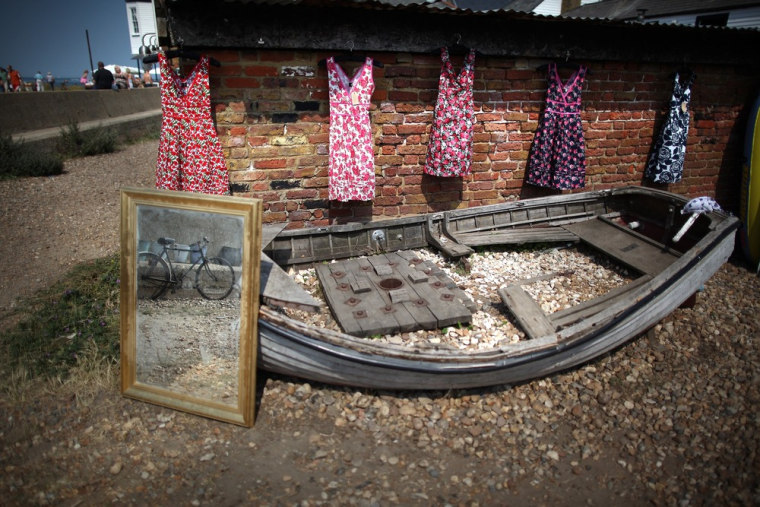 Dresses for sale hang above an old rowing boat on the seafront on Wednesday in Whitstable.