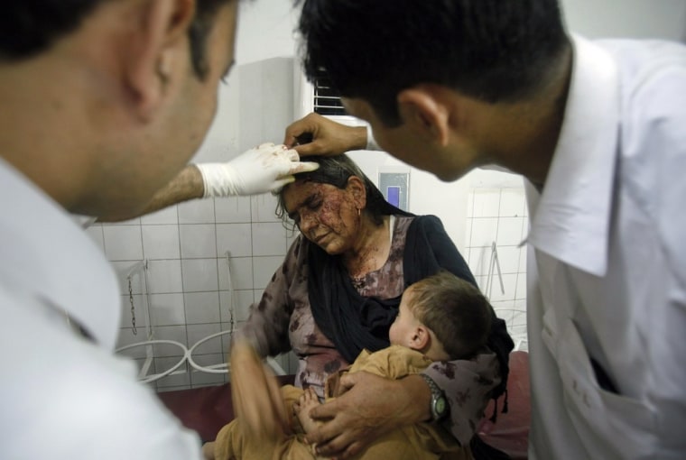 Paramedics attend to a woman who was wounded in the attack.