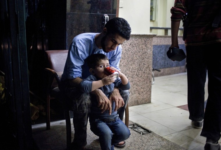 A doctor playing with a colleague's son, who lives with his parents and a brother at Dar al Shifa hospital, Aleppo, on October 13, 2012. Photo made available to NBC News on October 15.