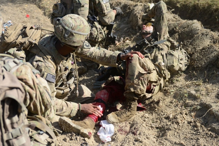 Private Ryan Thomas receives medical assistance after he was injured.