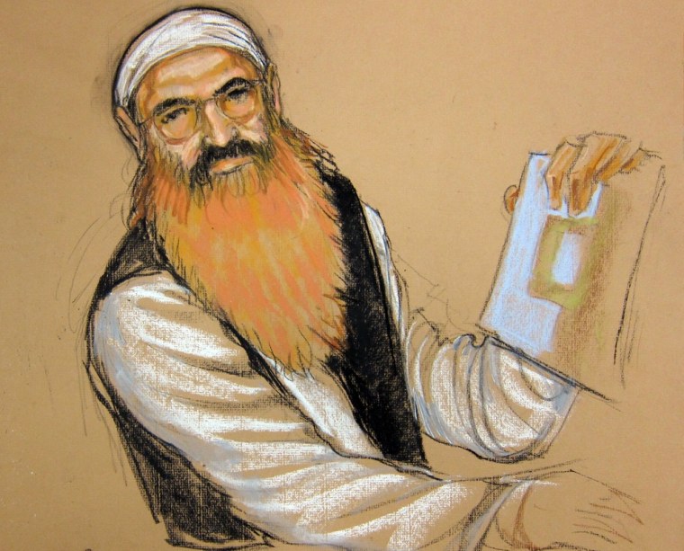 This courtroom sketch shows alleged 9/11 mastermind Khalid Sheikh Mohammed as he holds up a piece of paper during a court recess at his hearing on Monday at the U.S. Navy base in Guantanamo Bay, Cuba.