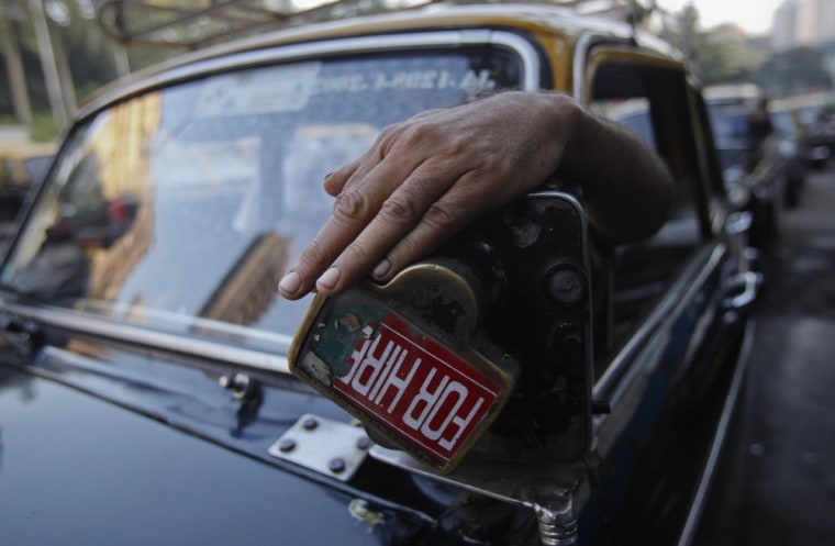 A driver demonstrates the use of a manually operated fare meter on October 12, 2012.