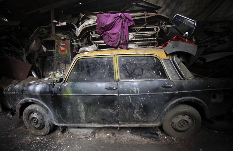 A de-registered Premier Padmini taxi is pictured covered in dust with love hearts etched on its windows in a scrapyard in Mumbai on October 2, 2012.