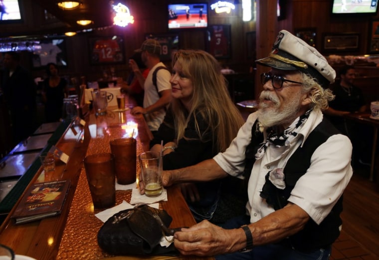 Roberto Francois Carranta of Miami, 84, a supporter of former Massachusetts Gov. Mitt Romney, watches the debate in Coral Gables, Fla.