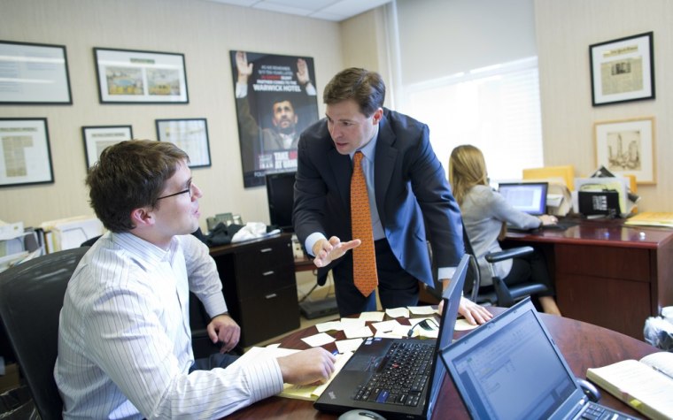 Mark Wallace, right, talks with United Against Nuclear Iran Executive Director David Ibsen in the group's New York City offices.