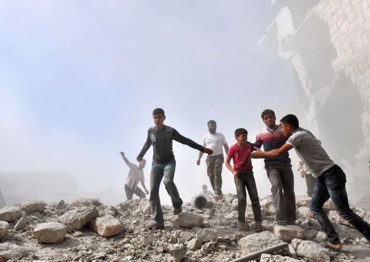 Syrian youths react following an airstrike by government forces in Maaret al-Numaan on Oct. 18.
