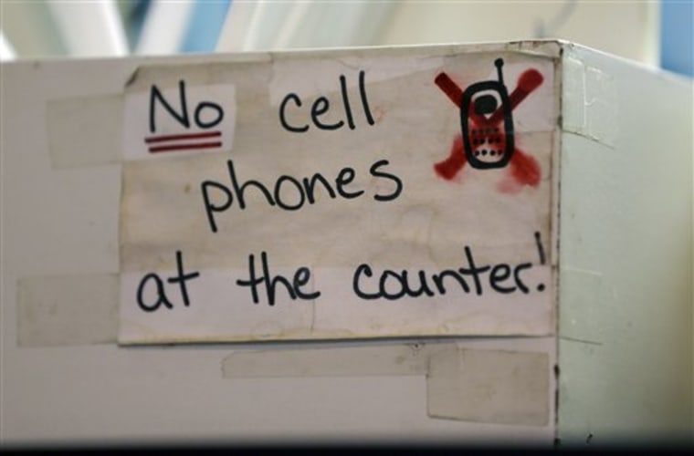 A sign at the Hamilton Street Cafe advises customers about cell phone policy at the restaurant, in Albany, N.Y.