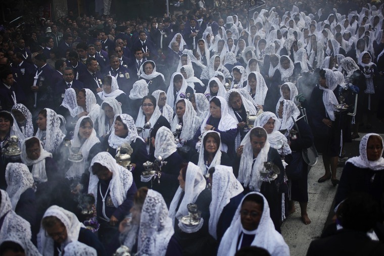 Women participate in a procession honoring