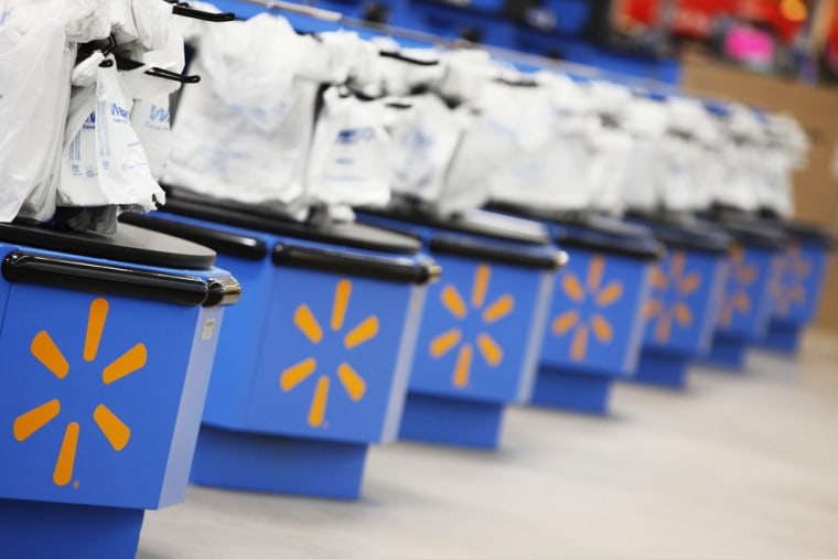 The Wal-Mart logo is pictured on cash registers at a new store in Chicago, this year. Brick-and-mortar merchants such as Wal-Mart will be pulling out all the stops to compete with online retailers such as Amazon.com this holiday season.