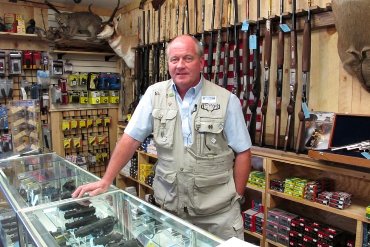 This photo taken Aug. 22, 2012, shows Central Wisconsin Firearms owner Frederick Prehn in his store in Wausau, Wis. He says he's had to expand his business to the new location last summer because of increased gun sales.