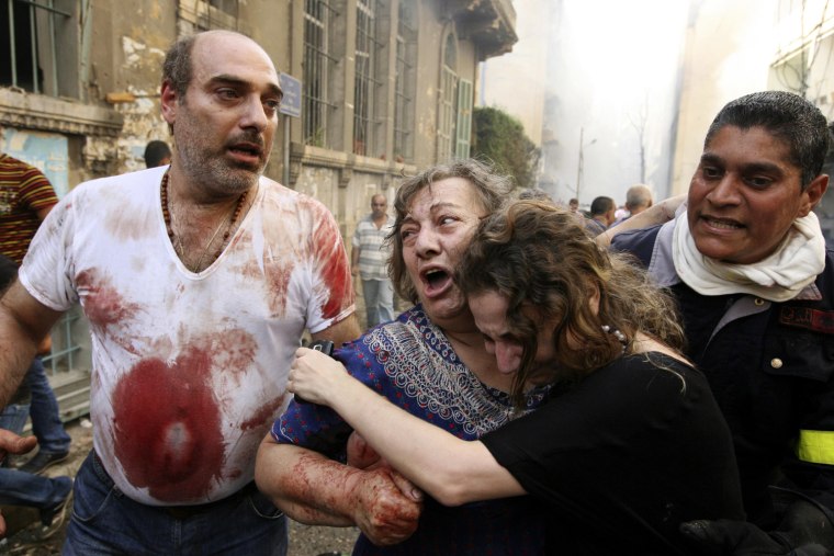 Relatives comfort a wounded woman at the site of an explosion in Ashafriyeh, central Beirut, on Oct. 19.