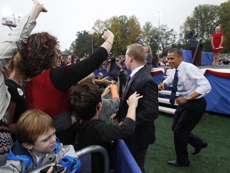 President Barack Obama stops mid-stride to greet supporters during a campaign rally at George Mason University in Fairfax, Va., Oct. 19, 2012.