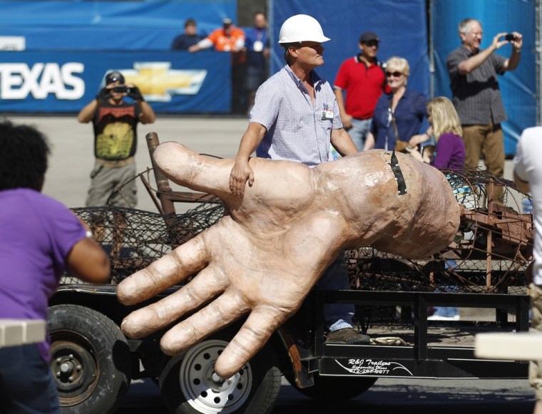 A worker hangs onto a surviving hand from