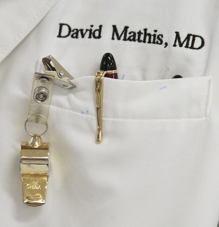 A whistle hangs from Dr. David Mathis' coat pocket as he does his rounds on Sept. 12. The whistle is worn in case he needs help in an emergency.