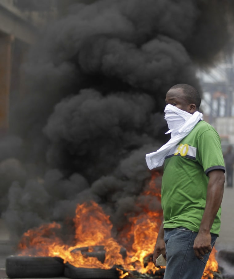 A protester stands at a road block in Colon City, Panama, Oct. 19.