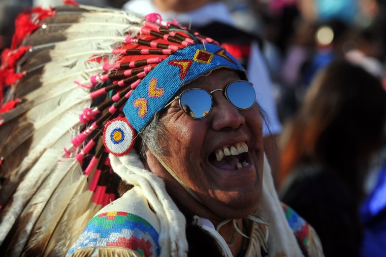 A faithful wearing Indian headress attends a special mass to name seven new saints in St Peter's square at Vatican on Sunday.