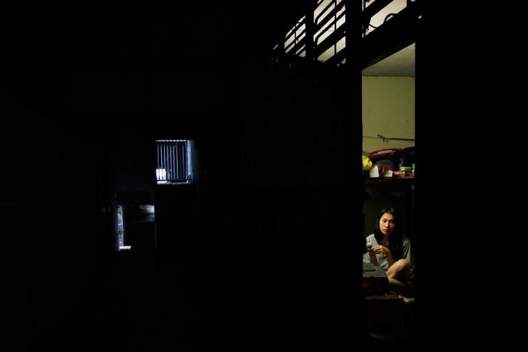 A girl stays at home inside an old block at a poor residential area in northern Macau, near the border checkpoint with the neighbouring city of Zhuhai, Oct. 10.