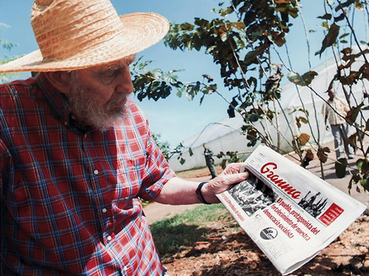 Fidel Castro holds up Friday's edition of Granma.