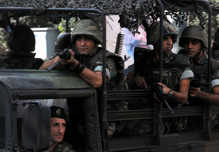 Lebanese Army soldiers patrol a neighborhood after overnight clashes between Sunni and Shiite gunmen in Beirut, Oct. 22, 2012. Shortly before noon Lebanese troops began a big operation in the capital aiming to open all closed roads and to force gunmen out of the streets after overnight clashes following the funeral of Lebanese Brig. Gen. Wissam al-Hassan.