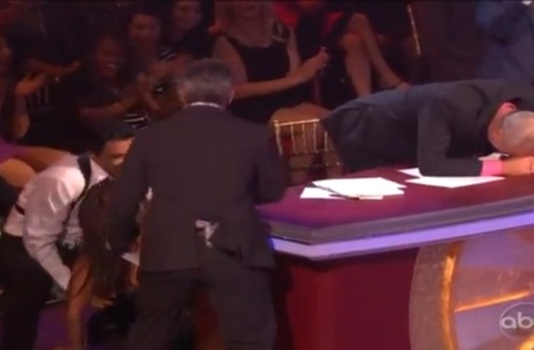 Carrie Ann Inaba falls out of her chair after watching Gilles Marini's rumba on \"Dancing With the Stars.\"