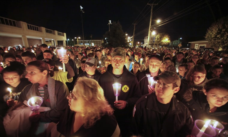 Members of the community participate in a candlelight vigil for Autumn Pasquale, on Oct. 22, in Clayton, N.J. About 200 law enforcement officials and hundreds more volunteers searched Monday for a southern New Jersey girl who disappeared over the weekend, raising anxiety in a rural town and pulling residents together.