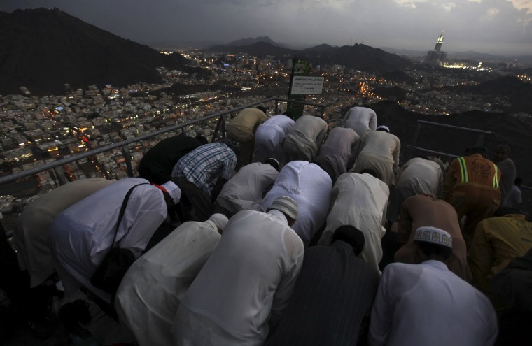 Muslim pilgrims pray at the top of Mount Noor, Oct. 21.